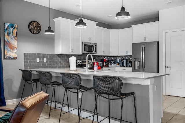 2907 Fable St, Kissimmee, FL 34746 - kitchen with stainless steel appliances, a peninsula, backsplash, and light countertops