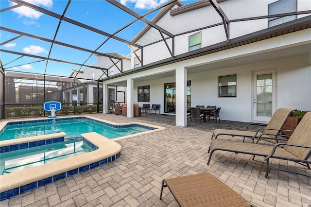 2907 Fable St, Kissimmee, FL 34746 - view of pool with outdoor dining area, a patio, a pool with connected hot tub, and glass enclosure