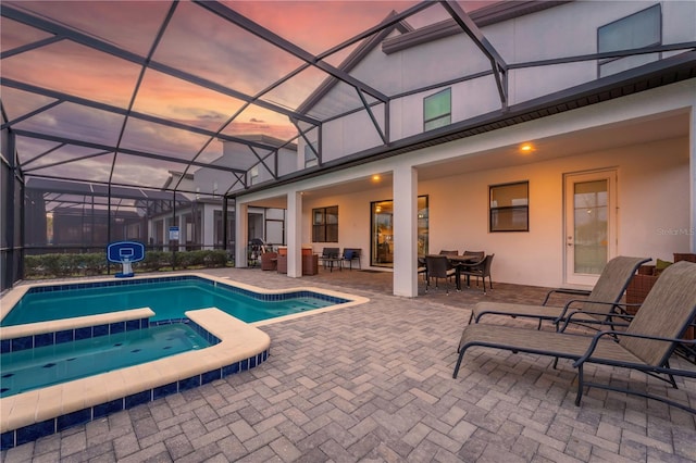 2907 Fable St, Kissimmee, FL 34746 - view of pool featuring outdoor dining space, a patio, a pool with connected hot tub, and glass enclosure
