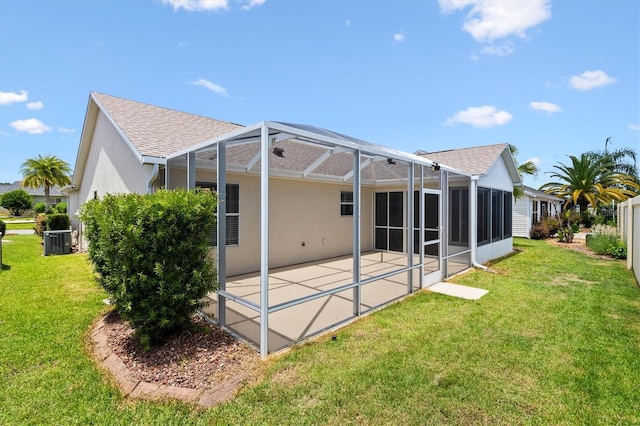449 Timmonsville Way, The Villages, FL 32162 - rear view of property featuring a patio, roof with shingles, a yard, and glass enclosure