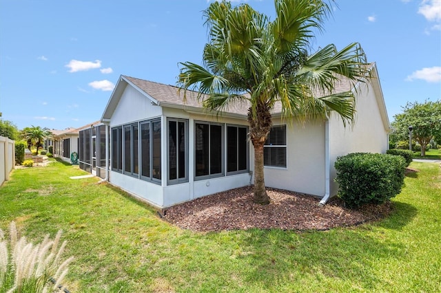 449 Timmonsville Way, The Villages, FL 32162 - back of property with a sunroom, a yard, and stucco siding