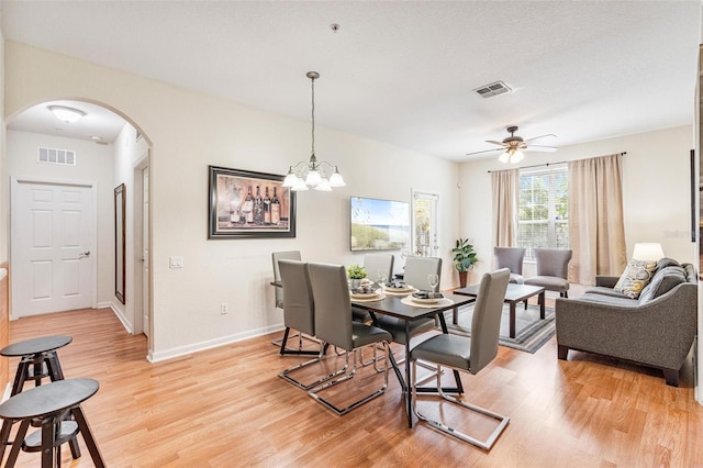 4114 Breakview Dr Unit 110, Orlando, FL 32819 - dining space with arched walkways, light wood-type flooring, and ceiling fan