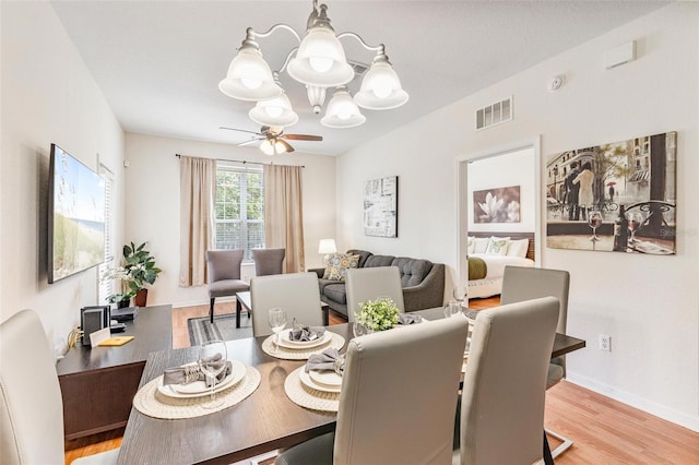 4114 Breakview Dr Unit 110, Orlando, FL 32819 - dining area with a chandelier, light wood-style flooring, and a ceiling fan