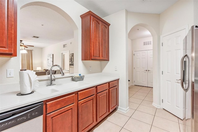 4114 Breakview Dr Unit 110, Orlando, FL 32819 - kitchen featuring dishwashing machine, arched walkways, freestanding refrigerator, light tile patterned floors, and ceiling fan