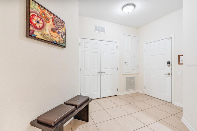 4114 Breakview Dr Unit 110, Orlando, FL 32819 - foyer featuring light tile patterned floors and a textured ceiling