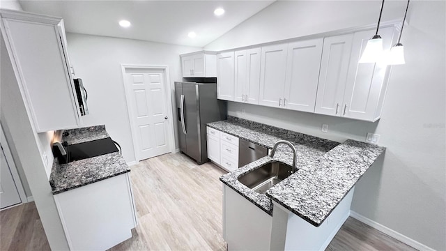4413 Grass Ave, Sebring, FL 33875 - kitchen featuring appliances with stainless steel finishes, white cabinets, dark stone counters, light wood-type flooring, and a peninsula