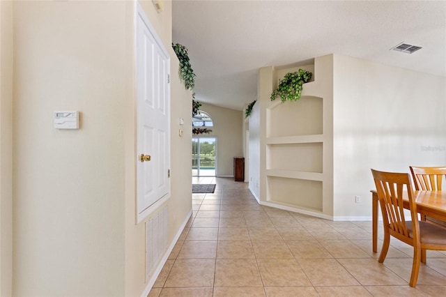162 Canary Island Cir, Davenport, FL 33837 - corridor featuring built in shelves, light tile patterned flooring, and lofted ceiling