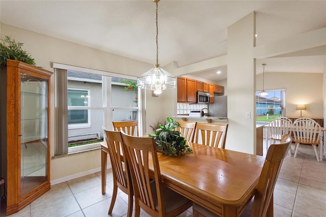 162 Canary Island Cir, Davenport, FL 33837 - dining area with a chandelier, light tile patterned floors, and lofted ceiling
