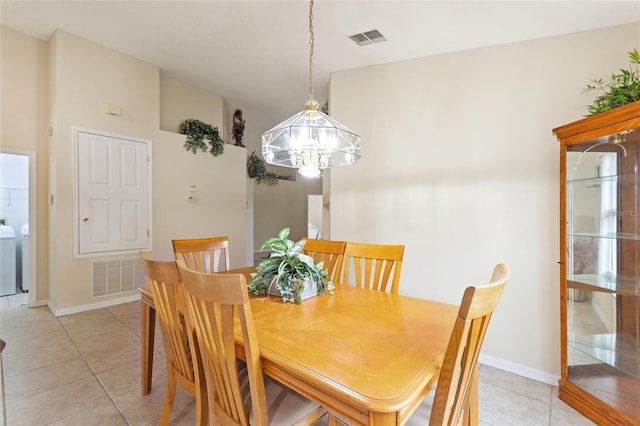 162 Canary Island Cir, Davenport, FL 33837 - dining room with a chandelier, light tile patterned floors, and independent washer and dryer