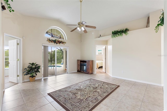 162 Canary Island Cir, Davenport, FL 33837 - unfurnished living room with light tile patterned floors, a ceiling fan, and high vaulted ceiling