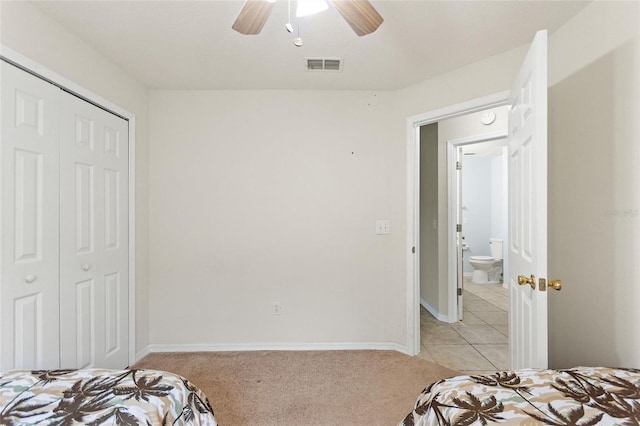 162 Canary Island Cir, Davenport, FL 33837 - bedroom featuring a closet, light colored carpet, a ceiling fan, and light tile patterned floors