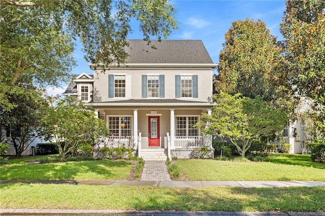 11333 Camden Park Dr, Windermere, FL 34786 - view of front of property with a porch, a front lawn, and stucco siding