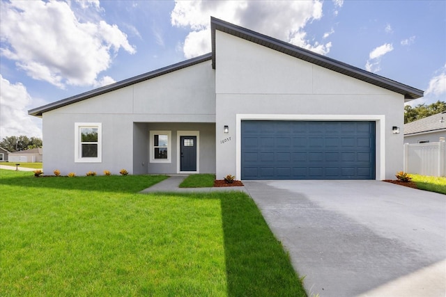 16057 SW 17th Ave, Ocala, FL 34473 - contemporary house with driveway, a front yard, a garage, and stucco siding