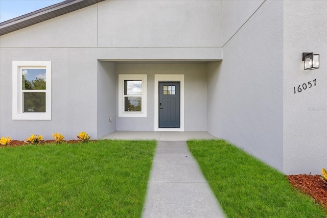16057 SW 17th Ave, Ocala, FL 34473 - property entrance featuring a yard and stucco siding