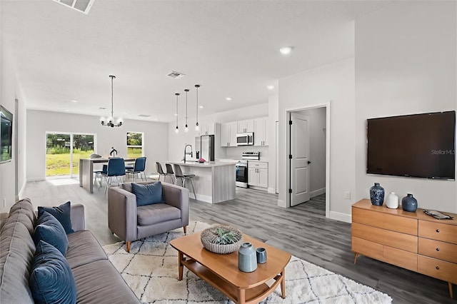 16057 SW 17th Ave, Ocala, FL 34473 - living room with a chandelier, light wood-style floors, and recessed lighting