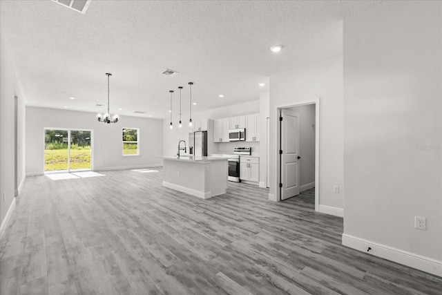 16057 SW 17th Ave, Ocala, FL 34473 - unfurnished living room with a chandelier, light wood-type flooring, recessed lighting, and a textured ceiling