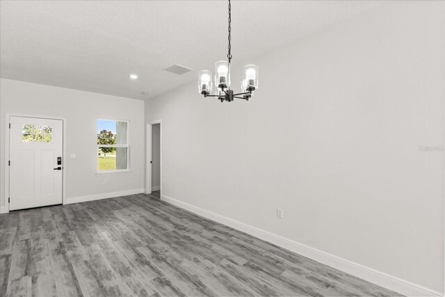 16057 SW 17th Ave, Ocala, FL 34473 - unfurnished dining area with a chandelier, wood finished floors, and recessed lighting