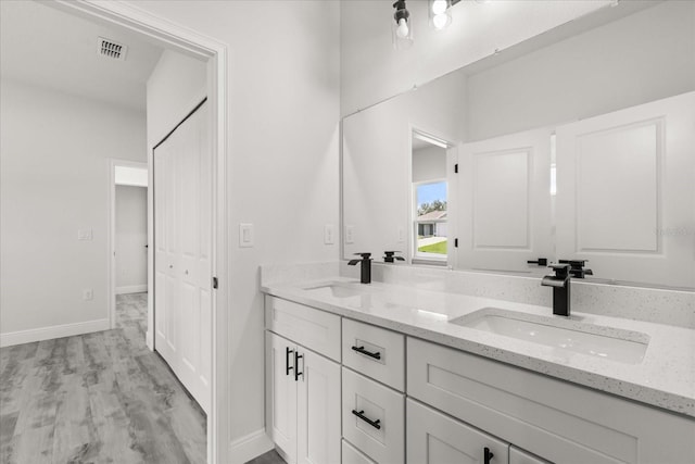 16057 SW 17th Ave, Ocala, FL 34473 - bathroom featuring double vanity and wood finished floors
