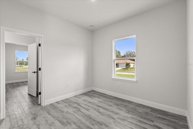 16057 SW 17th Ave, Ocala, FL 34473 - unfurnished room with healthy amount of natural light and light wood-style flooring