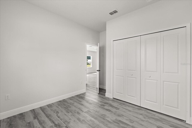 16057 SW 17th Ave, Ocala, FL 34473 - unfurnished bedroom featuring wood finished floors and a closet