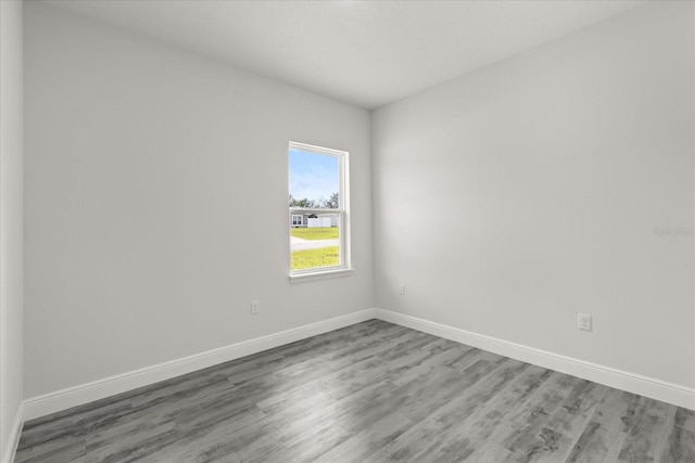 16057 SW 17th Ave, Ocala, FL 34473 - spare room featuring wood finished floors and baseboards
