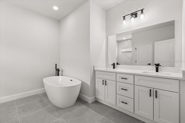 16057 SW 17th Ave, Ocala, FL 34473 - full bathroom featuring double vanity, a freestanding bath, a shower, tile patterned flooring, and recessed lighting