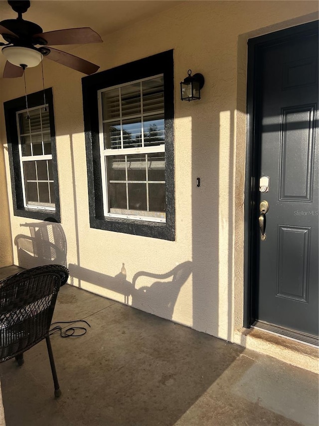 4805 SW 171st Ct, Dunnellon, FL 34432 - property entrance featuring stucco siding, a ceiling fan, and covered porch