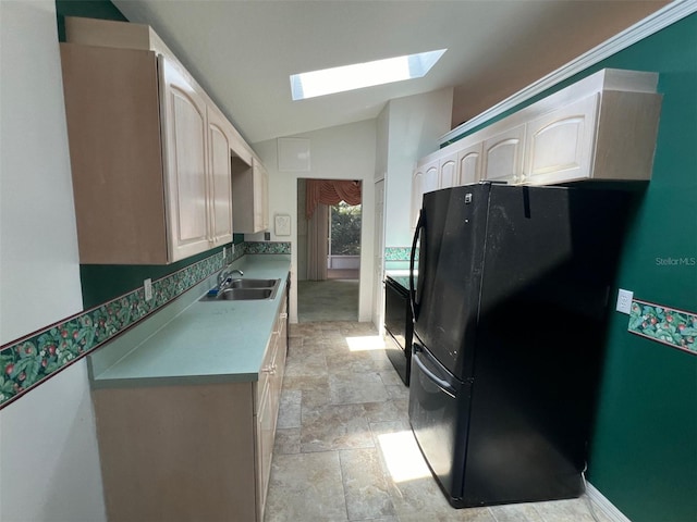 1082 S Fork Cir, Melbourne, FL 32901 - kitchen with freestanding refrigerator, a skylight, vaulted ceiling, light stone finish floors, and stove