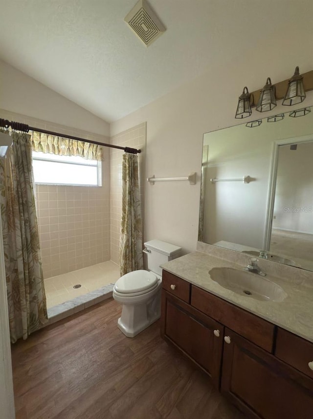 1082 S Fork Cir, Melbourne, FL 32901 - full bathroom with tiled shower, lofted ceiling, wood finished floors, and vanity