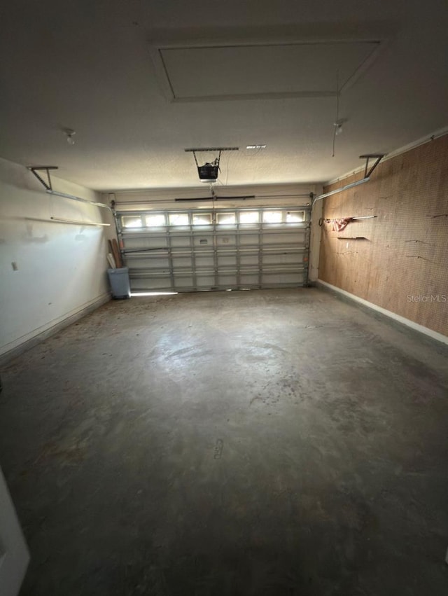 1082 S Fork Cir, Melbourne, FL 32901 - garage featuring a garage door opener and wood walls