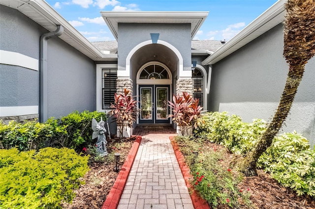 1640 Wild Indigo Ter, Oviedo, FL 32766 - doorway to property with stucco siding, french doors, and stone siding