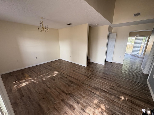 266 Vervain Ave, Davenport, FL 33837 - unfurnished room featuring dark wood-style floors, a chandelier, and a textured ceiling