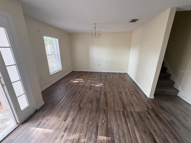 266 Vervain Ave, Davenport, FL 33837 - unfurnished dining area with a chandelier, wood finished floors, stairs, and a textured ceiling