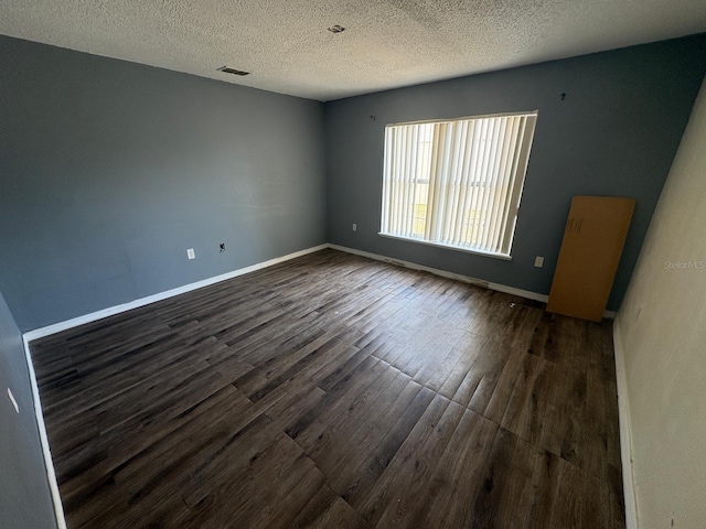 266 Vervain Ave, Davenport, FL 33837 - unfurnished room featuring dark wood-type flooring and a textured ceiling
