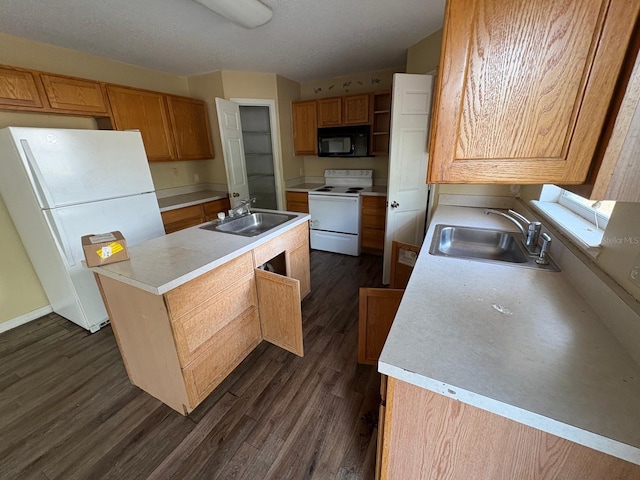 266 Vervain Ave, Davenport, FL 33837 - kitchen featuring white appliances, a center island with sink, dark wood-style floors, and light countertops