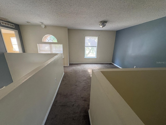 266 Vervain Ave, Davenport, FL 33837 - hall featuring an upstairs landing, carpet, and a textured ceiling