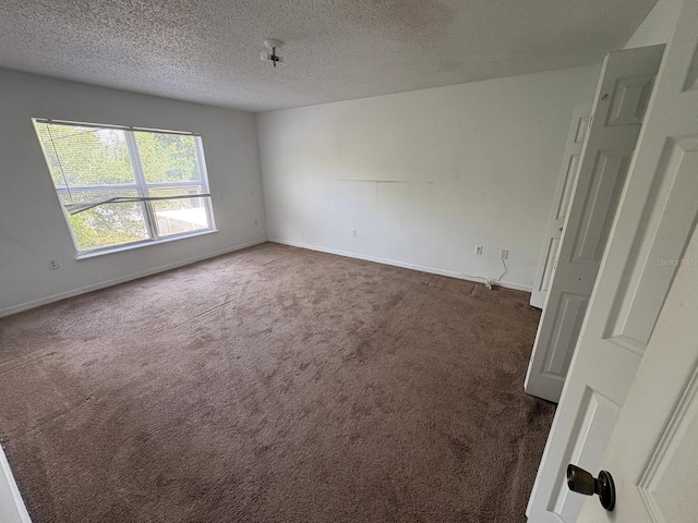 266 Vervain Ave, Davenport, FL 33837 - carpeted spare room with a textured ceiling and baseboards