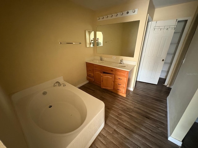 266 Vervain Ave, Davenport, FL 33837 - full bathroom with wood finished floors, a bath, and double vanity