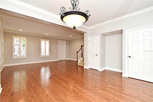 1649 Lake Baldwin Ln, Orlando, FL 32814 - unfurnished living room with stairway, wood finished floors, crown molding, a chandelier, and recessed lighting