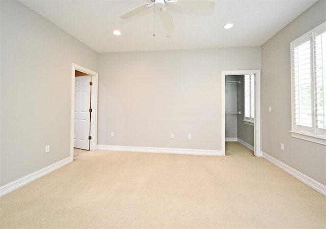 1649 Lake Baldwin Ln, Orlando, FL 32814 - unfurnished bedroom with light carpet, multiple windows, a walk in closet, recessed lighting, and ceiling fan