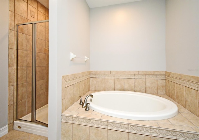 1649 Lake Baldwin Ln, Orlando, FL 32814 - full bathroom featuring a garden tub, a shower stall, and tile patterned flooring