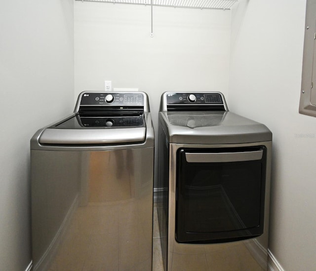 1649 Lake Baldwin Ln, Orlando, FL 32814 - laundry area featuring separate washer and dryer, tile patterned flooring, and electric panel