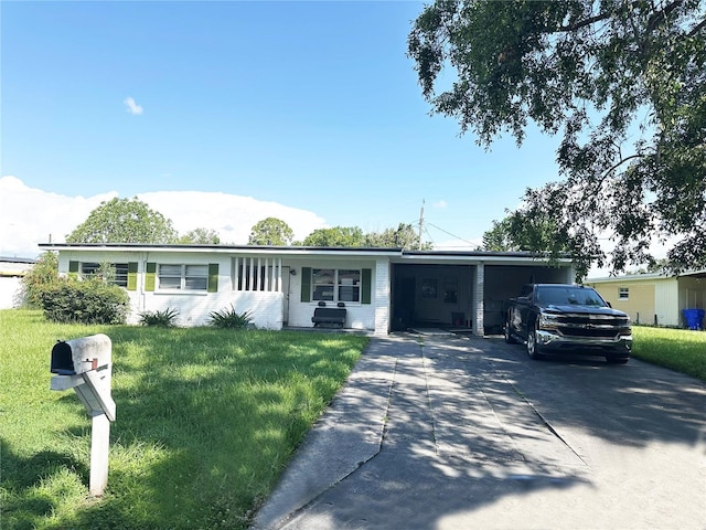 107 Dellwood Dr, Kissimmee, FL 34744 - single story home with driveway, an attached carport, and a front yard