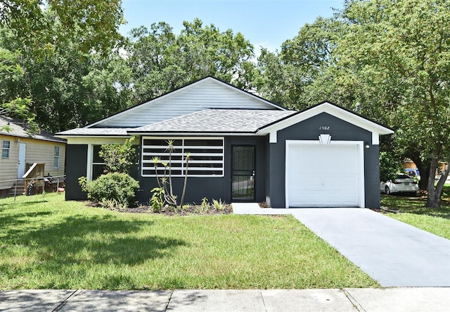 1502 W 16 Th St, Sanford, FL 32771 - view of front of house with a shingled roof, a garage, driveway, a front yard, and stucco siding