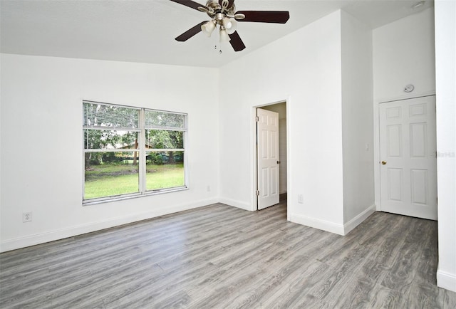 1502 W 16 Th St, Sanford, FL 32771 - unfurnished room with wood finished floors, a ceiling fan, and a high ceiling
