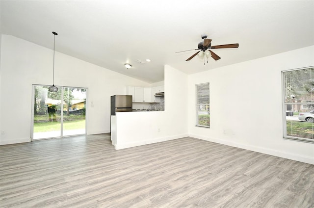 1502 W 16 Th St, Sanford, FL 32771 - unfurnished living room with ceiling fan, light wood-style floors, healthy amount of natural light, and high vaulted ceiling