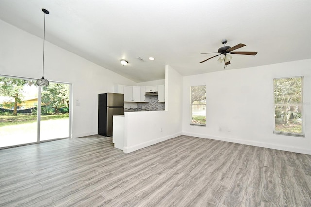 1502 W 16 Th St, Sanford, FL 32771 - unfurnished living room featuring a ceiling fan, light wood-type flooring, and high vaulted ceiling