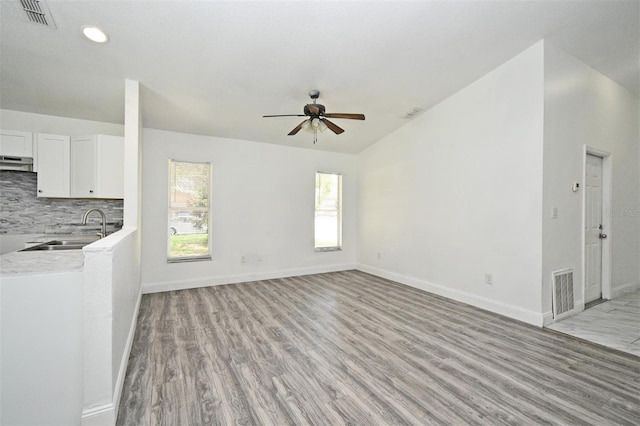 1502 W 16 Th St, Sanford, FL 32771 - unfurnished living room with ceiling fan, light wood-type flooring, lofted ceiling, and recessed lighting