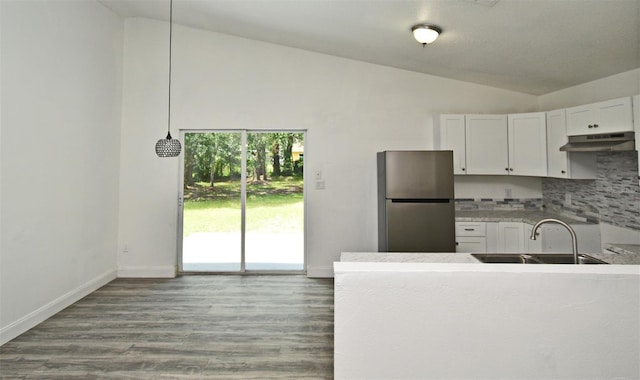 1502 W 16 Th St, Sanford, FL 32771 - kitchen with freestanding refrigerator, lofted ceiling, under cabinet range hood, decorative backsplash, and white cabinets