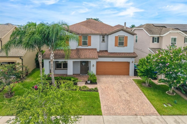 1270 Fountain Coin Loop, Orlando, FL 32828 - view of front of home with stucco siding, decorative driveway, an attached garage, and a front lawn